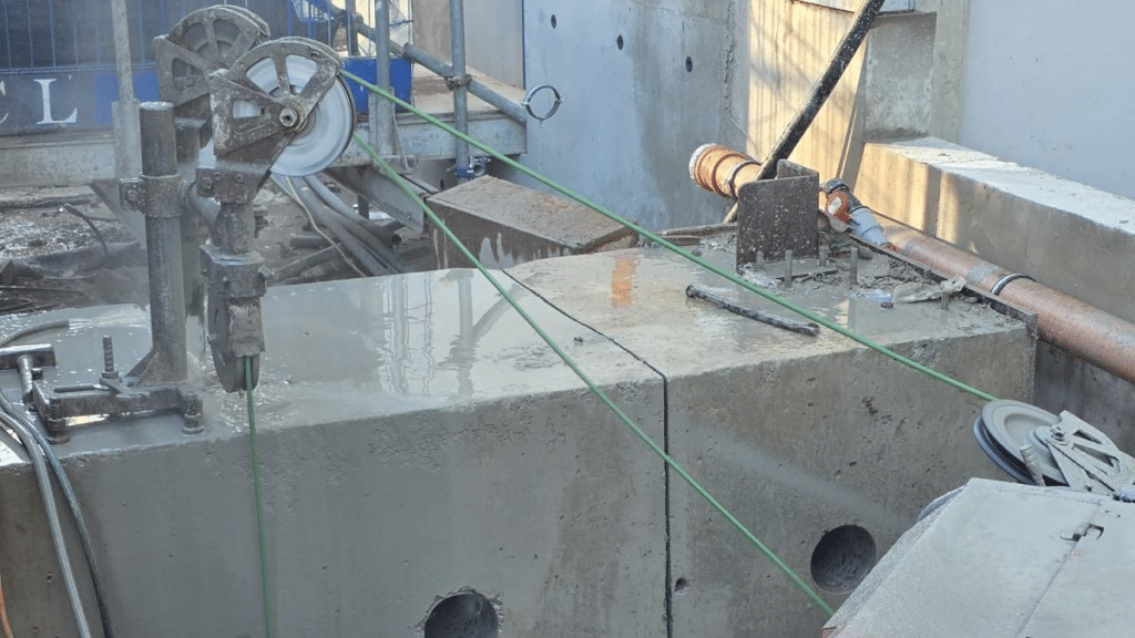 Diamond wire cutting a concrete block with a clean, precise cut on site